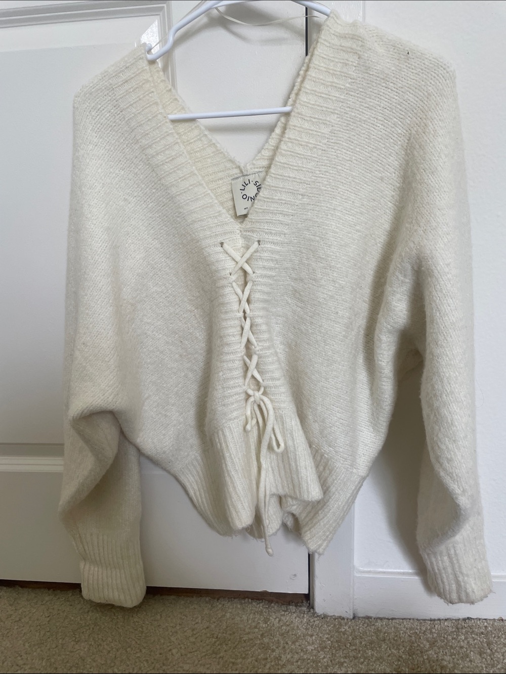 Lace-Up V-Neck Cream Sweater with cross detailing